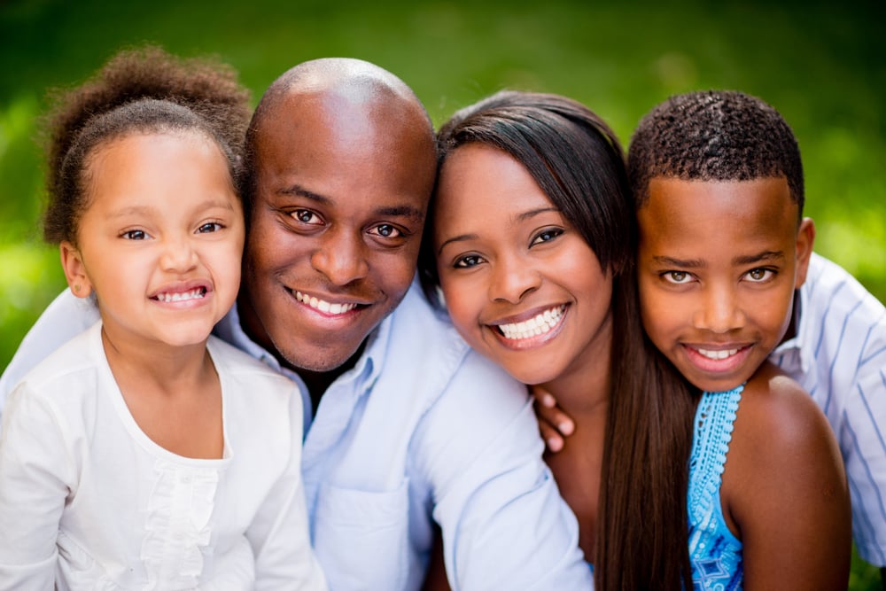Portrait of an African American family looking very happy outdoors