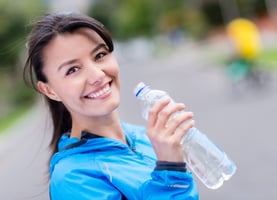 Smiling Active Woman Drinking Water From Bottle