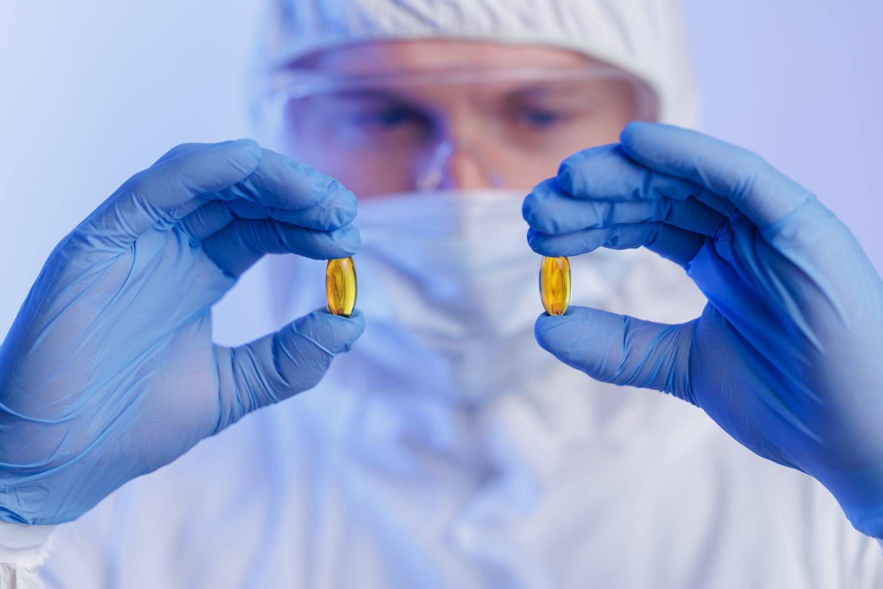 AdobeStock_Quality control of omega fish oil yellow capsules by medical production worker-1800